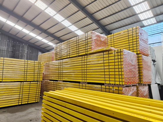 Yellow H20 timber beams stacked for formwork shoring system